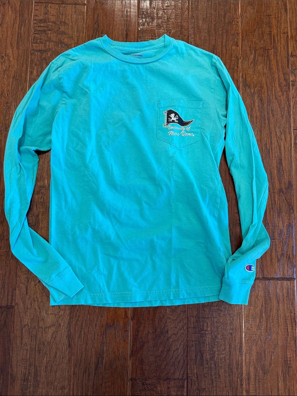 EUC Champion Turquoise Long Sleeve Pocket Tee with Notre Dame Pocket Graphic